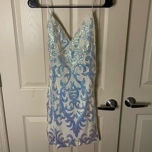 This dress is white with sequined patterns.